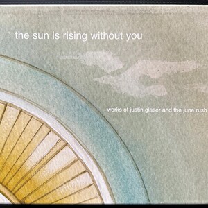 May include: Square artwork with a watercolor design. The image features a partial view of a yellow and white wheel, a light blue curved line, and a light green background with the text "the sun is rising without you" and "works of justin glaser and the june rush."
