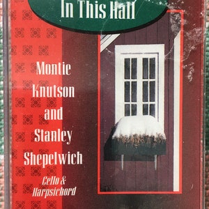 May include: A cassette tape with a red and green background. The text "Masters In This Hall" is in a green oval. The text "Montie Knutson and Stanley Shepelwich Cello & Harpsichord" is in black text.