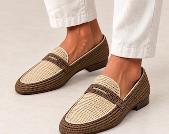 May include: A pair of slip-on loafers featuring a woven texture in two-tone olive green and cream. The shoes have a rounded toe, a classic penny loafer strap across the vamp, and a low heel, constructed with a structured, braided material design.