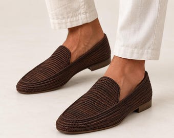 May include: A pair of dark brown woven loafers with a textured, braided surface and a low heel. The shoes feature a slip-on design with a rounded toe and a solid, matching brown sole, providing a clean and uniform appearance for the footwear.