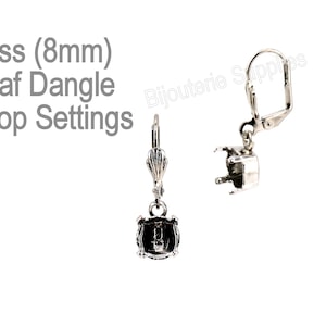 May include: Silver leaf dangle drop earring settings for 8mm stones. The settings have a hook closure and a leaf design.