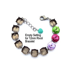 May include: Empty setting for a 12mm Rivoli bracelet. The bracelet is made of silver tone metal and has a clasp closure. The setting is designed to hold a 12mm Rivoli crystal.