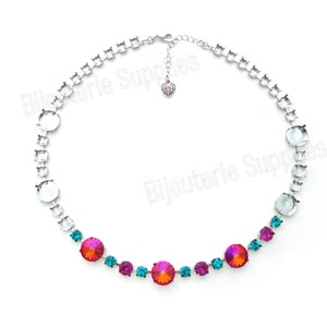 May include: A silver chain necklace with a pink heart charm and a row of round, iridescent gemstones in shades of teal and pink.