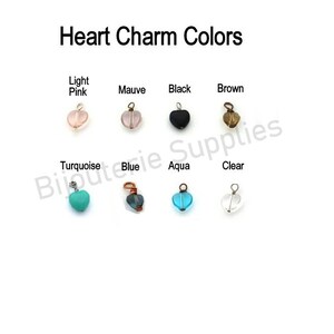 May include: Heart charm colors: light pink, mauve, black, brown, turquoise, blue, aqua, and clear. Each charm is a small heart-shaped bead with a loop for attaching to a necklace or bracelet.