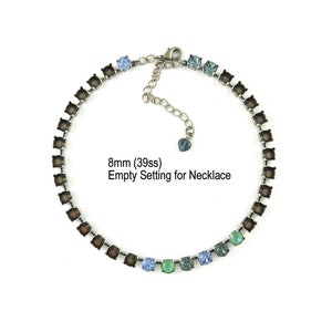 May include: A necklace setting with a silver-tone chain and square settings. The settings are empty, ready for stones. The necklace has a gradient of blue and green stones. Text reads: 8mm (39ss) Empty Setting for Necklace.