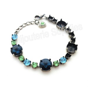 May include: A silver bracelet with a chain and a heart charm. The bracelet is adorned with blue, green, and light blue round stones.