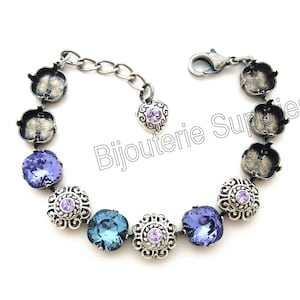 May include: A silver bracelet with a chain and a clasp. The bracelet has a series of silver settings with purple and blue crystals.