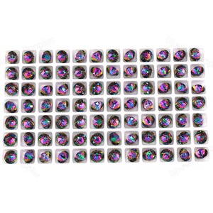 May include: A white tray filled with 64 iridescent rainbow-colored glass rhinestones.
