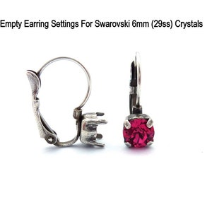 May include: Empty earring settings for 6mm Swarovski crystals. The settings are silver-toned and have a lever back closure. The crystals are a vibrant red color.