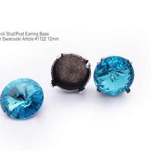 May include: Three silver earring bases with a turquoise blue crystal. The bases are for 12mm Swarovski crystals. The text "Rivoli Stud/Post Earring Base For Swarovski Article #1122 12mm" is visible in the image.