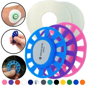 May include: A set of colorful, round, plastic holders with a central opening. The holders are designed to fit around a medical device. The holders are available in blue, purple, pink, and white. The text "Dexcom Demo" is printed on the blue holder.