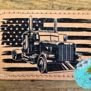 May include: A rectangular patch featuring a black semi-truck design set against a distressed American flag. The patch has a stitched border and a light brown background. The design is a patriotic theme.
