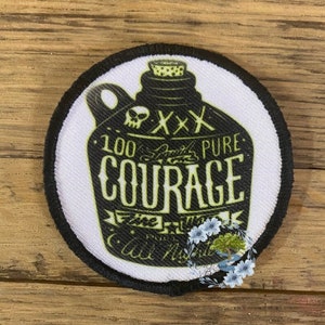 May include: A round black and white patch with a black and white illustration of a bottle with the text "100% Smith's Pure Courage" and a skull and crossbones.