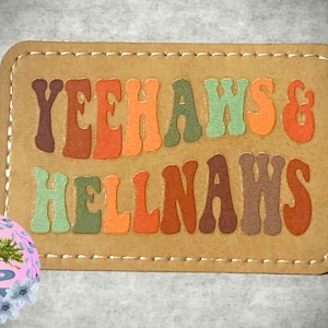 May include: A brown leather patch with the text "Yeehaws & Hellnaws" in colorful, retro-style lettering.