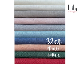May include: A stack of 10 different colors of 32 count matte fabric. The colors are white, off-white, gray, light pink, light blue, blue, peach, green, and red. The fabric is labeled "32ct Matte Fabric".