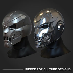 May include: Two silver helmets with detailed designs. The helmets have a futuristic, sci-fi aesthetic.  The helmets are on black mannequins.  The text "PIERCE POP CULTURE DESIGNS" is at the bottom of the image.