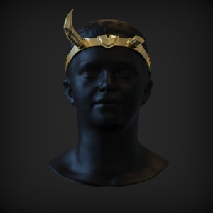 May include: A black mannequin head wearing a gold crown with horns. The crown has a pointed design and is decorated with a small shield in the centre.