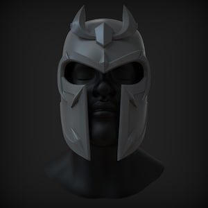 Peut inclure: Un casque gris avec une couronne pointue et un masque facial. Le casque a une surface textur&eacute;e et un design angulaire et pointu.