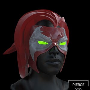 May include: A red and silver superhero mask with bright green mesh eye lenses worn on a black mannequin head. The mask features a sculpted red hair piece and a textured silver eye area. The text PIERCE POP CULTURE is visible in a white box.