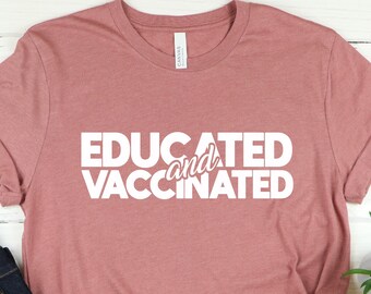May include: A pink t-shirt with the text "EDUCATED and VACCINATED" in white lettering.