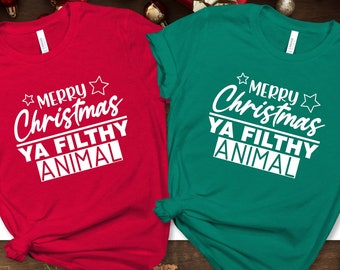 May include: Two t-shirts with the text "Merry Christmas Ya Filthy Animal" in white lettering on a red and green shirt.