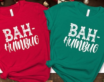 May include: Two Christmas themed t-shirts with the text "Bah-Humbug" in white on a red and green shirt.
