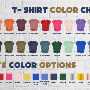 May include: A color chart for t-shirts and font options against a white brick wall. The t-shirt color options include various shades of peach, orange, red, pink, purple, gray, and white. Font color options include black, white, red, pink, yellow, blue, green, silver, gold, and neon colors.