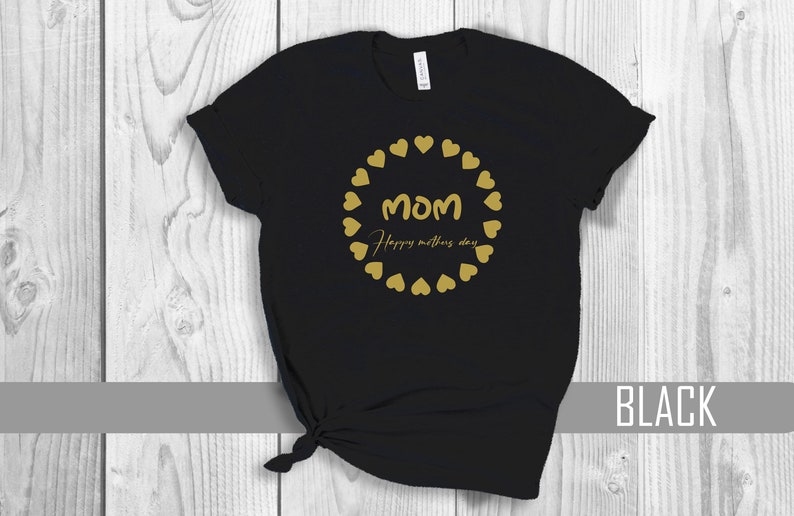 May include: Black t-shirt with a gold circle of hearts and the text "MOM Happy Mother's Day".