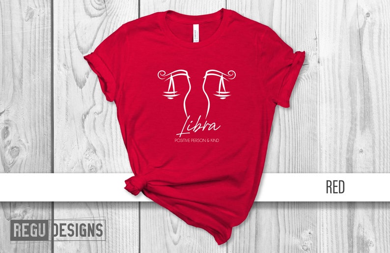 May include: Red t-shirt with a white Libra zodiac symbol and the text "Positive Person & Kind".