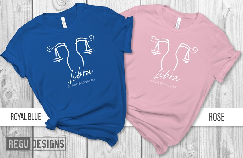 May include: Two t-shirts, one royal blue and one rose, with a white Libra zodiac symbol and the text "Libra, Positive Person & Kind".