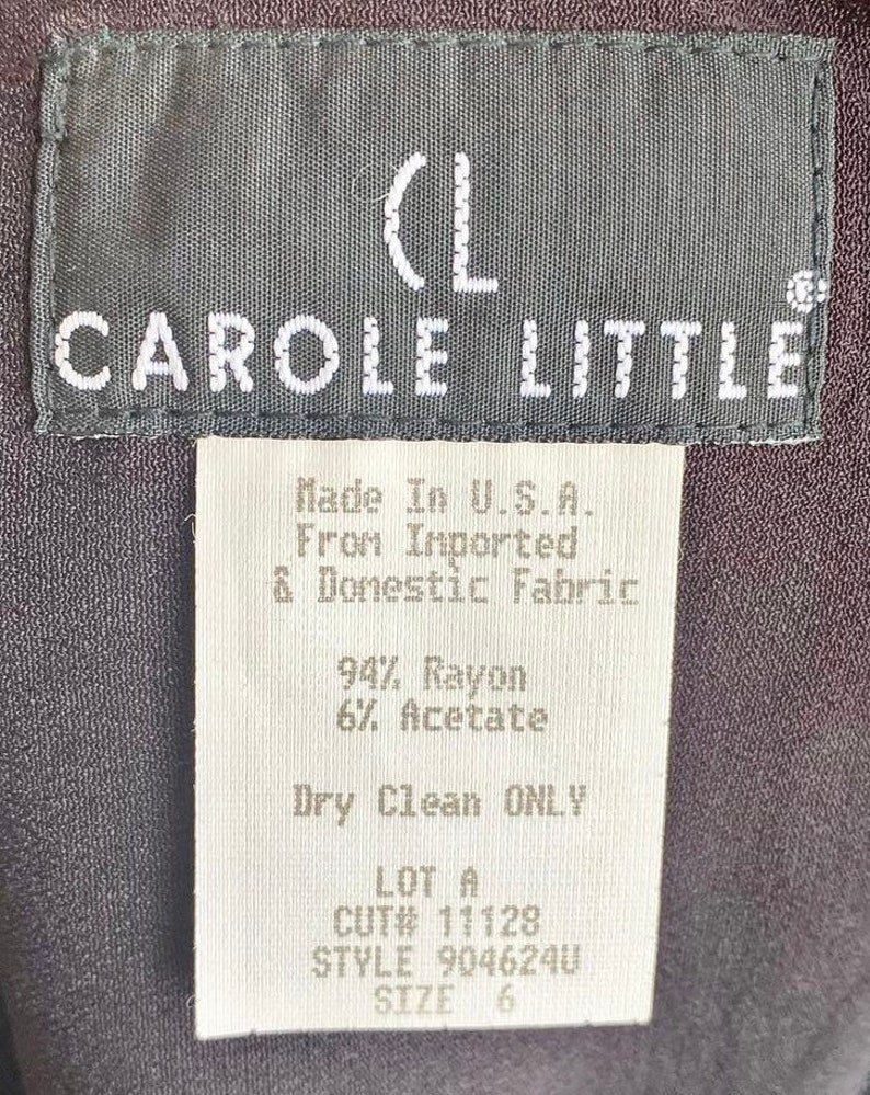 May include: A white tag with black text that reads "(L CAROLE LITTLE Made In U.S.A. From Imported & Domestic Fabric 94% Rayon 6% Acetate Dry Clean ONLY LOT A CUT# 11128 STYLE 904624U SIZE 6"