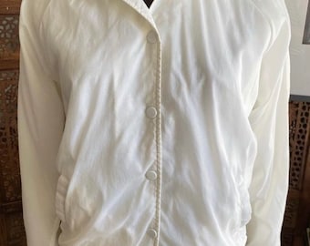 Vintage 80s white windbreaker with snap button closers by Rainbow Sportswear