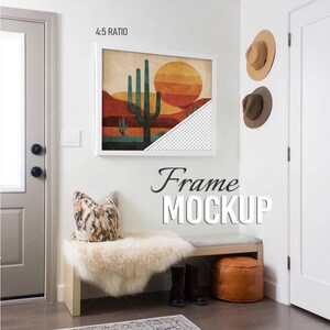 May include: A white picture frame mockup containing a desert landscape print with a saguaro cactus and a large sun. The bottom right corner of the print shows a transparent checkerboard pattern. The text 4:5 RATIO and Frame MOCKUP are visible.
