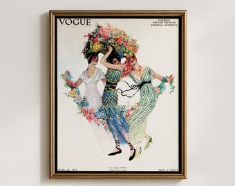 May include: A framed vintage Vogue magazine cover from June 1913. The artwork features three women in flowing dresses, adorned with flowers, and a large floral headdress. The magazine title "VOGUE" is at the top, with text below.