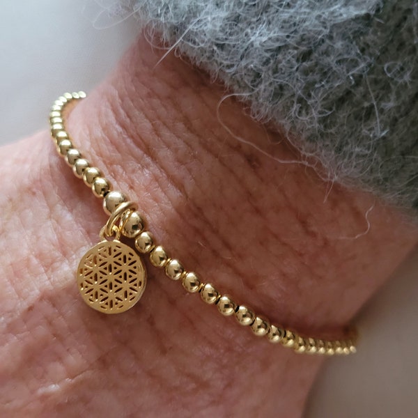 Goldenes Kugelarmband mit Blume des Lebens