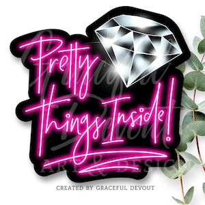 May include: A black sticker with the text "Pretty Things Inside!" in a neon pink script. A diamond graphic is at the top right. The words "ART & DESIGN" and "CREATED BY GRACEFUL DEVOUT" are at the bottom.