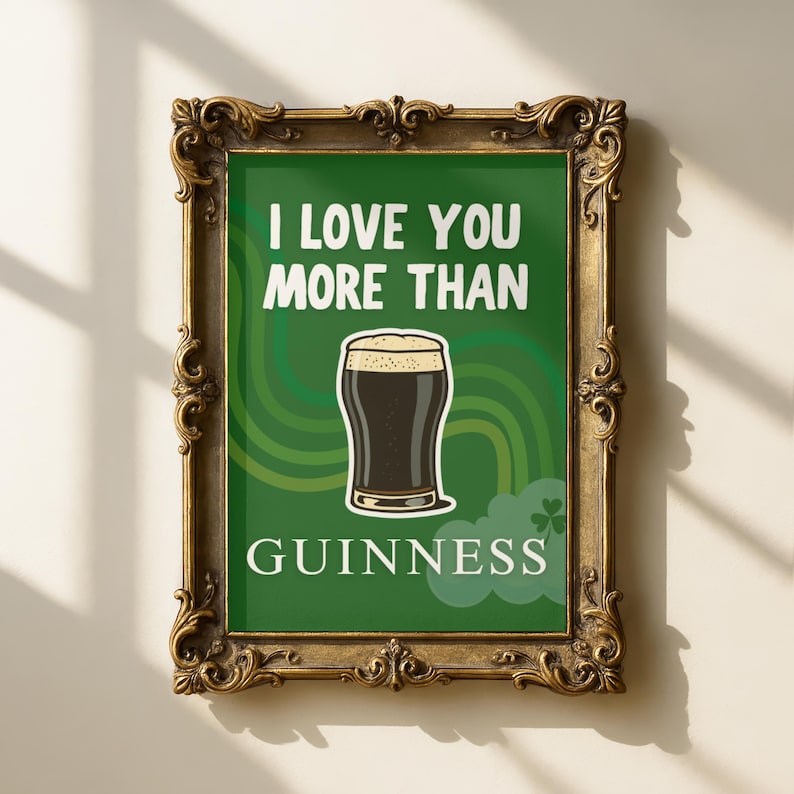 May include: A framed print with a green background and the words "I LOVE YOU MORE THAN GUINNESS" in white. The image features a pint of Guinness stout. The frame is ornate and gold-coloured.