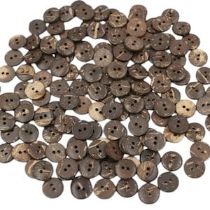 May include: A large pile of brown coconut shell buttons. The buttons have two holes each.