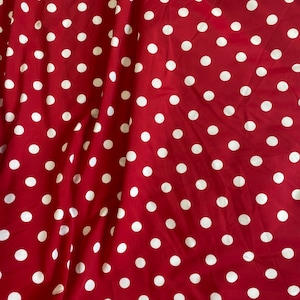 red and white polka dot fabric stretches for 4, both are sold by the yard