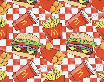 May include: A repeating pattern featuring cartoon illustrations of hamburgers, french fries, chicken nuggets, and soft drinks on a red and white checkered background. The fast food items are in red packaging.