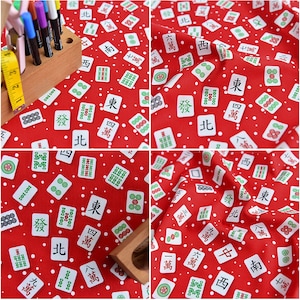 May include: Red fabric with a white background featuring a repeating pattern of Mahjong tiles. The tiles have Chinese characters and symbols. The fabric is perfect for crafting projects.