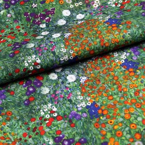 May include: Floral fabric featuring a variety of colourful flowers. The fabric has a green background with orange, red, purple, white, and blue flowers. The fabric is folded over, showing the pattern.