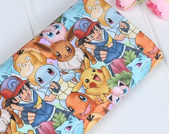 May include: A colourful fabric with a repeating pattern of various Pokemon characters, including Pikachu, Squirtle, Bulbasaur, and Charmander. The fabric is white with a light blue, pink, and yellow background.