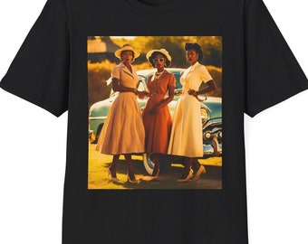 May include: Black t-shirt with a vintage photo of three women in dresses standing in front of a car. The women are smiling and looking at the camera. The car is a light blue color and has a white roof.