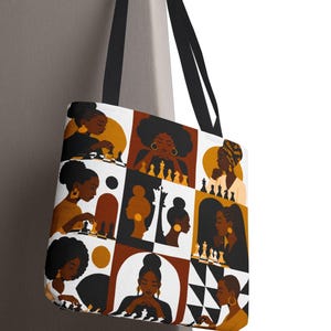 May include: A tote bag featuring a repeating grid pattern of illustrations depicting Black individuals playing chess. The color palette consists of black, white, brown, and gold tones. The bag has two black shoulder straps and a rectangular shape.