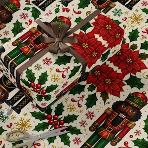 May include: Wrapping paper featuring a repeating pattern of nutcrackers, red poinsettias, green holly leaves, red berries, and gold snowflakes on a cream background, with a gift box wrapped in the same paper and a pair of silver scissors.