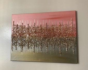 May include: Abstract art painting with a pink, silver, and gold glitter design. The glitter is layered in a dripping effect, creating a textured look.
