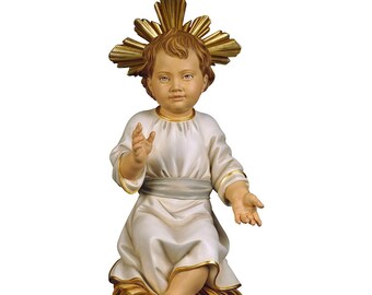 Statue sculpture of the seated baby Jesus, carved in wood from Valgardena and decorated by hand of Italian artisan production