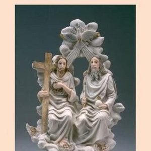 May include: A white porcelain figurine depicting Jesus and God the Father sitting on clouds with a dove above them. The figurine is on a black base.