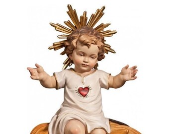 Sculpture statue of baby Jesus sitting on a cradle, carved in Valgardena wood and hand-decorated, of Italian artisan production